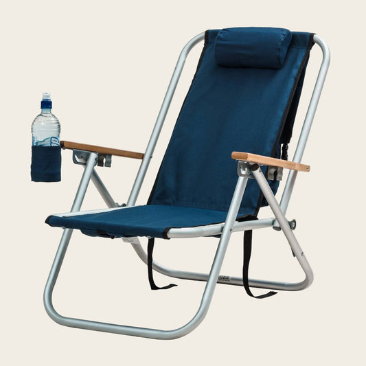 Portable Beachkit Wearever Backpack Chair with navy blue fabric, aluminum frame, wooden armrests, adjustable headrest, and drink holder.
