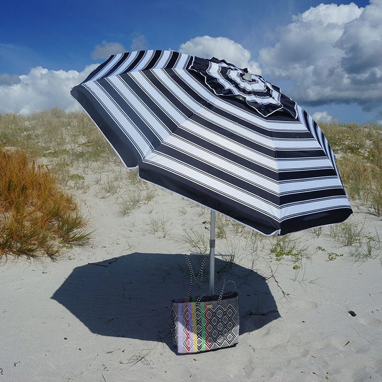 Daytripper Beach Umbrella 210cm black and white stripes on sandy beach with carry bag