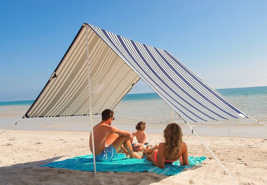 Lovin Summer beach shade tent with blue and white stripes providing UPF 40 sun protection on sandy beach
