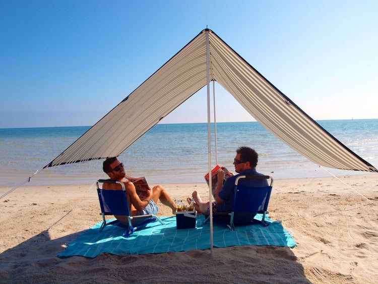 Lovin Summer Sombrilla shade tent on beach providing UPF 40 sun protection with lightweight cotton canvas and easy setup