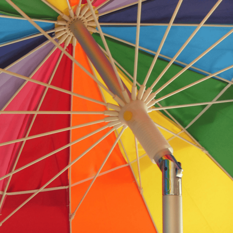 Close-up of the rainbow 240cm beach umbrella canopy with vibrant panels and sturdy frame structure